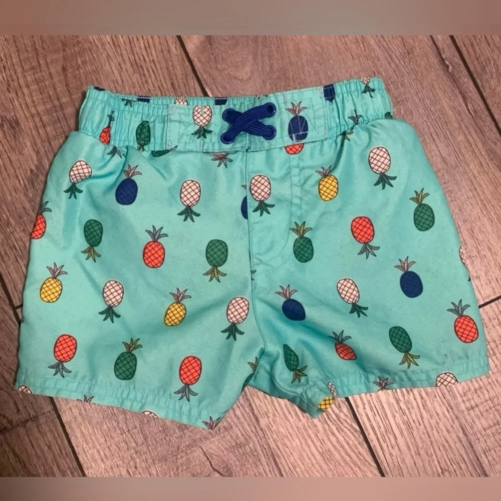 2 Pr. Boys Swim Trunks-Carter’s Crab Swim Trunks and Cat & Jack Pineappl…